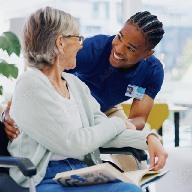 Provider helping patient in wheelchair